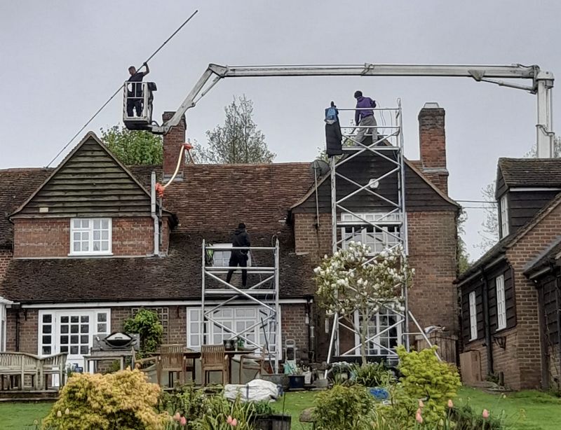 The Moss Cleaners using cherry picker and scaffolding to clean roof safely and professionally in Melksham, Wiltshire